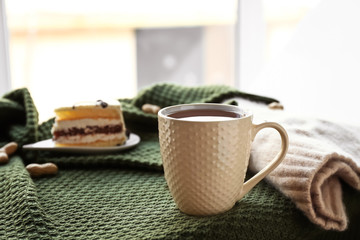 Cup of hot tea on plaid