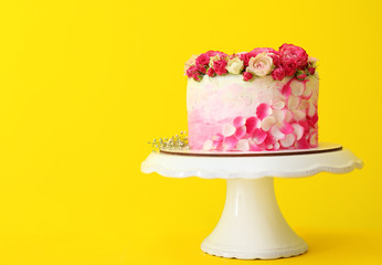 Stand with tasty Birthday cake on color background