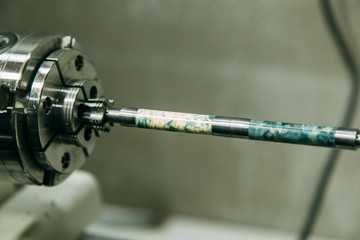 A piece of wood for turning. Workshop with machines.