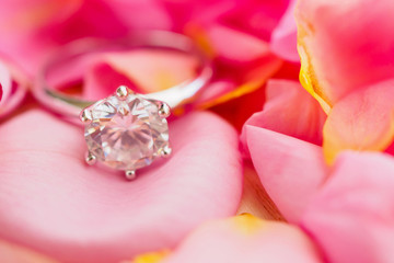 Jewelry diamond ring on beautiful pink rose petal background