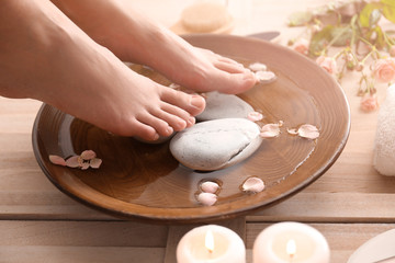 Young woman undergoing spa pedicure treatment in spa salon