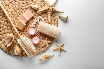 Massage brushes with cosmetics on white background