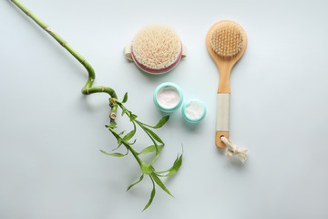 Massage brushes with cream on white background