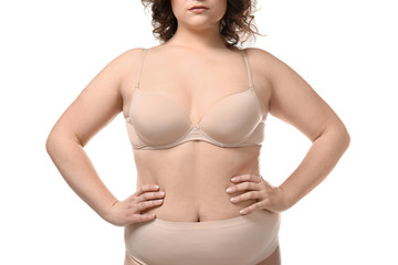 Plus size woman in underwear on white background