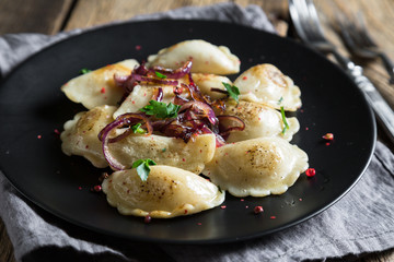 Fototapeta na wymiar Dumplings, pelmeni, pierogi, with fried onions
