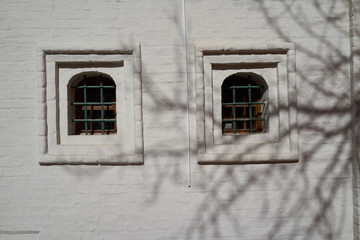two old windows on the background of a white brick wall. Moscow, Russia