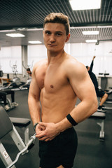 Fototapeta na wymiar Muscle guy posing in front of mirror