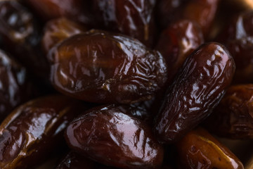 Khalas date palm on black granite table in side view with copy space. 