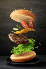 Delicious hamburger on blackboard - obrazy, fototapety, plakaty