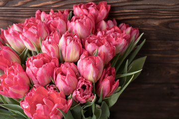Bouquet of tulips on dark wooden table