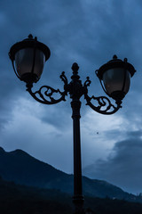 Metal lantern on the street against the background of the Caucasus Mountains late in the evening