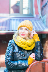 stylish girl portrait looking into the camera on an old street winter or spring time