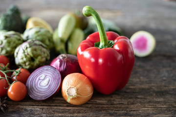many fresh vegetables on rustic wooden table