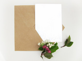 Top view background with flowers. Flowers composition.  Mockup card with plants. Mockup with postcard and flowers on white background.    