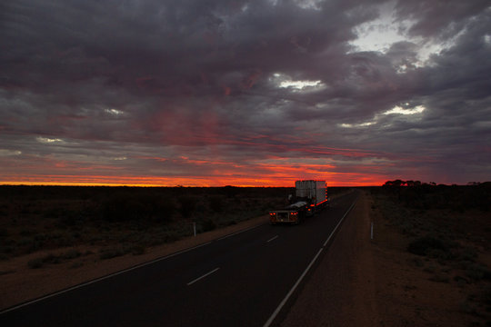 Roadtrain on stuart highway at night. A roadtrain use in remote areas of Australia to move freight efficiently, NORTHERN TERRITORY,Australia.