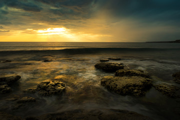 Fototapeta na wymiar sunset over the sea taken with long exposure,