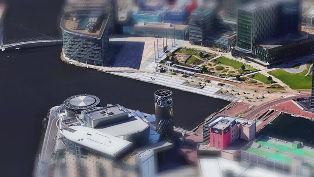 Helicopter shot going over media city on a sunny day