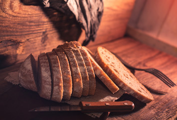 Rural still life with homemade bread on rustic background inthe morning light