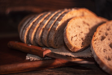 Rural still life with homemade bread on rustic background inthe morning light