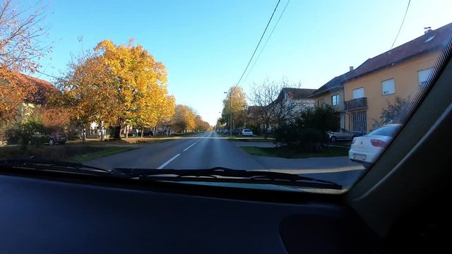 704 Short Car Drive On A Sunny Day Through Little Town With Some Traffic