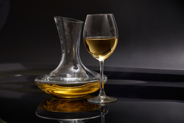 A glass full of wine and wine decanters