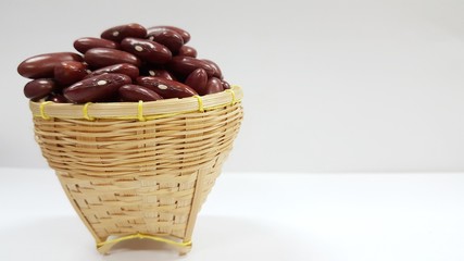 Red bean seeds in a basket with a white background. Red bean grains.