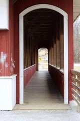 The long passage though the door of the covered bridge.