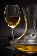 A glass full of wine and wine decanters