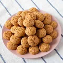 Homemade almond cookies on pink plate, low angle view. Close-up.