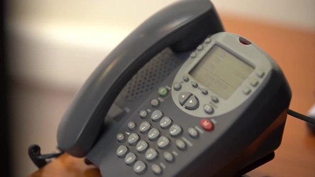 The Woman Puts Down The Old Wired Phone With Buttons, Then Picks Up The Phone Again And Dials The Phone Number, Then Hangs Up, Close-up