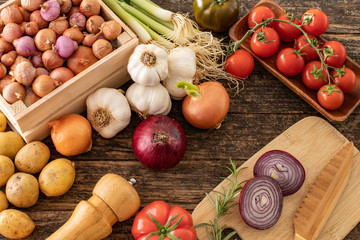 Several vegetables on the rustic table.
