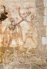 A 13th century a fresco skeleton dance on the outside wall of Basilica of St-Sauveur a Rocamadour, Episcopal city and sanctuary of the Blessed Virgin Mary, Lot, Midi-Pyrenees, France