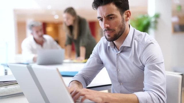 Startup team member working on computer in office