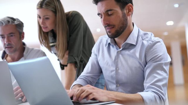 New startup company discussing ideas together in contemporary office 
