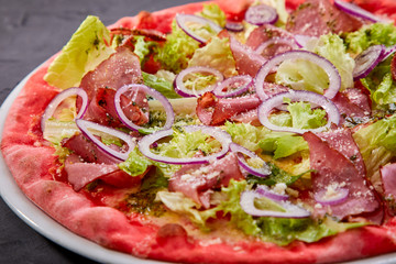 pizza with beef on the black background