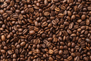 Roasted coffee beans background. Top view. Space for text.