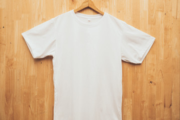 white short sleeve t-shirt plain round neck mock up concept idea wooden back ground  front view