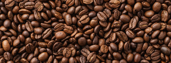 Roasted coffee beans background. Top view. Space for text.