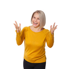 Middle aged blonde emotionally posing in a studio. Happy woman in yellow bright sweater on white background