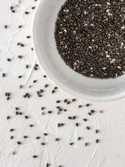 Chia seeds with copy space. Chia seed on white concrete textured background. Top view or flat lay. Copy space. Healthy food and diet concept