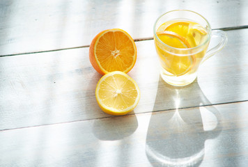 Orange-lemon drink in the gentle rays of the morning sun.