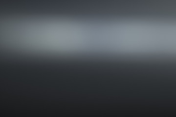 Smooth grey color gradient. Glowing abstract black background. Lens flare effect.