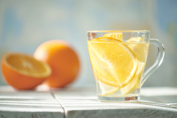 Orange-lemon drink in the gentle rays of the morning sun.
