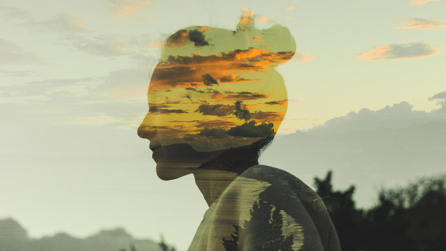 Warm Profile Double Exposure Portrait Of Young Woman With Hair Bun During Dusk