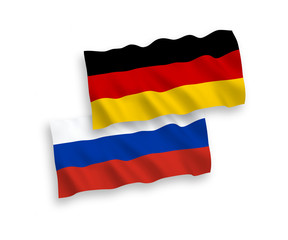 Obraz premium National vector fabric wave flags of Germany and Russia isolated on white background. 1 to 2 proportion.