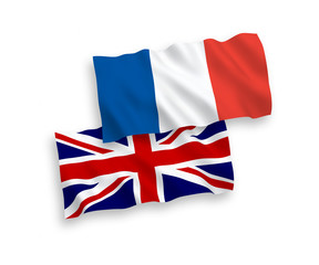 National vector fabric wave flags of France and Great Britain isolated on white background. 1 to 2 proportion.