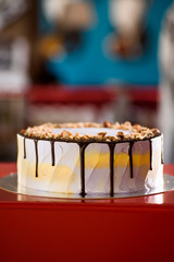 beautiful nut cake with purple mousse and chocolate on the  restaurant background. beautiful cut cake. close-up. purple icing