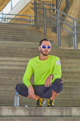 Sportsman working out / jogging on a big city urban bridge.
