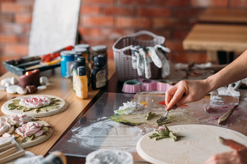 Artist workplace. Inspiration. Art craft skills. Female with modeling tools working in studio. Creative atmosphere.