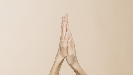 Women's hands on a beige background